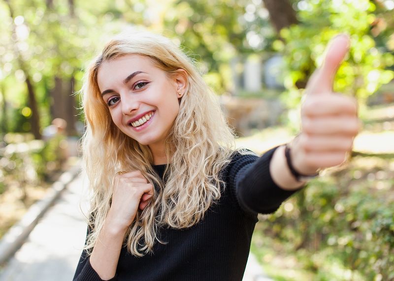 Happy one woman giving the thumbs up