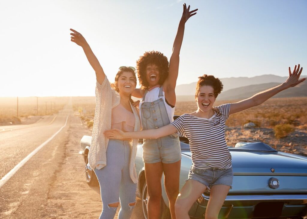 Friends posing for a photo on a road trip