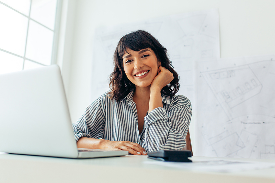 woman smiling in front of computer